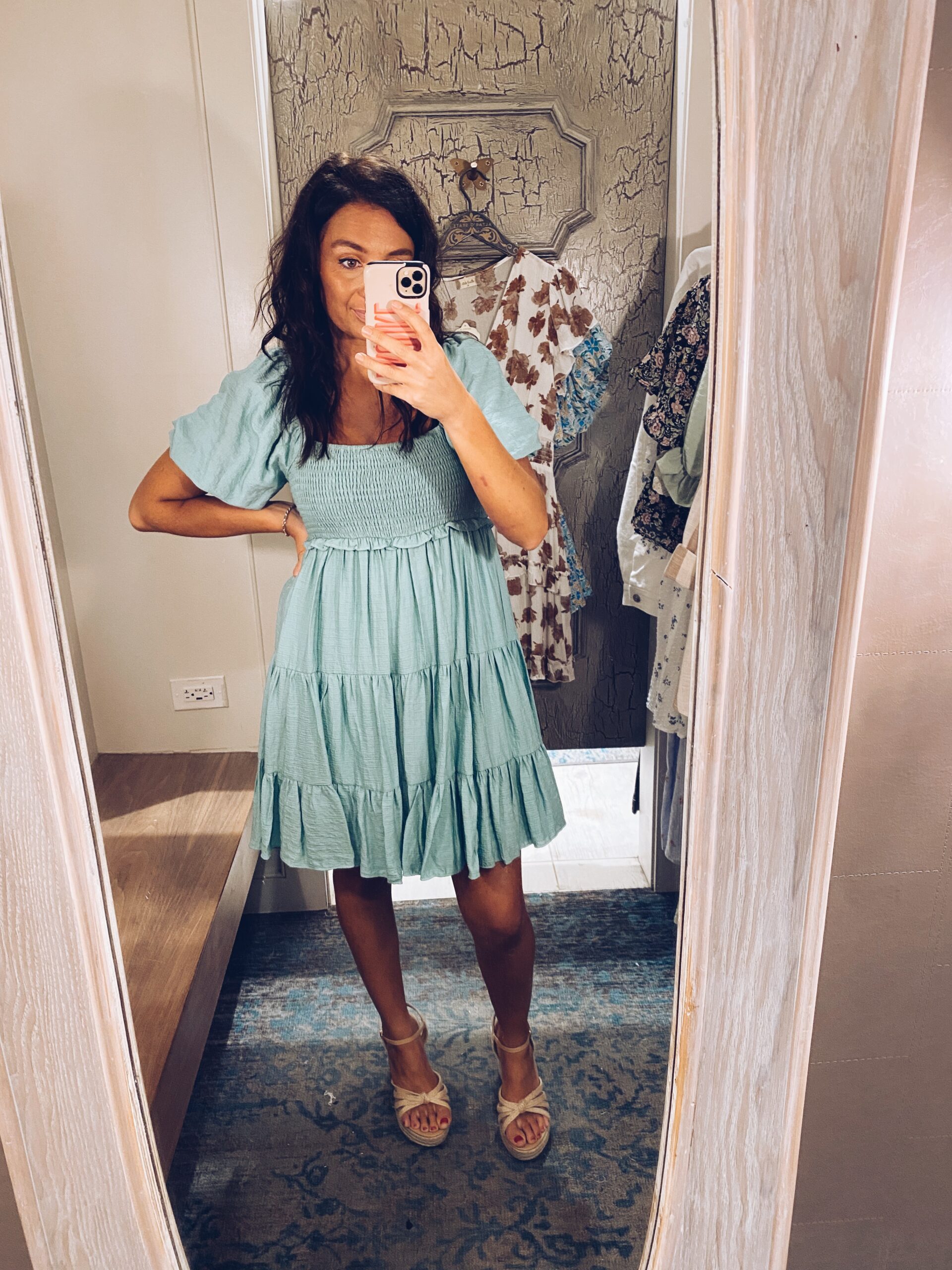 Girl posing in mirror wearing blue dress