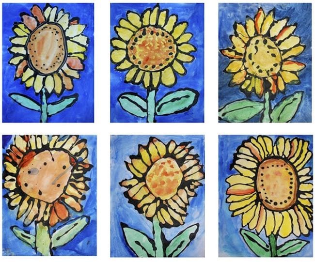 Sunflowers made by outlining them with black glue and filling in with water colors (First Grade Art)
