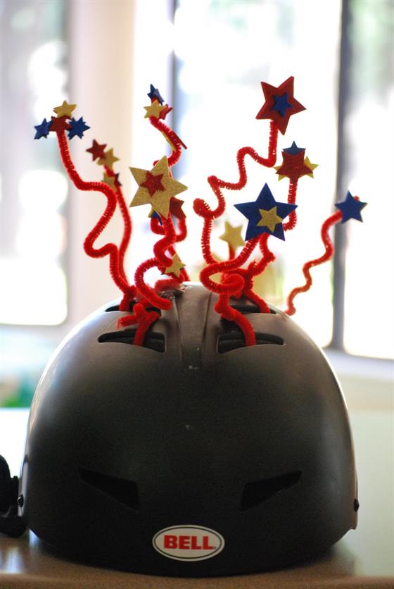 A bicycle helmet decorated with pipe cleaners and foam stars
