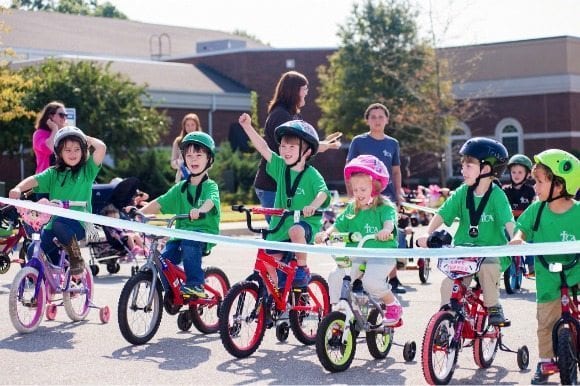 St. Jude trike-a-thon with kids riding their bikes in a line