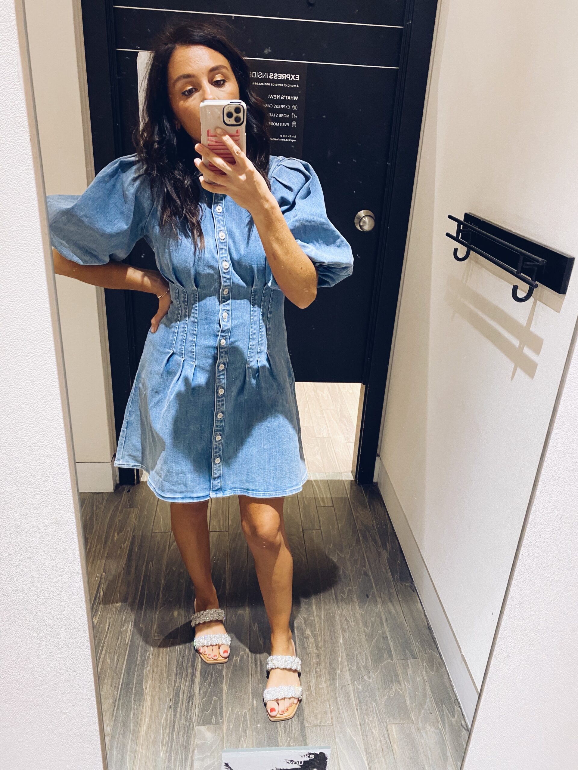 Woman in mirror wearing denim dress