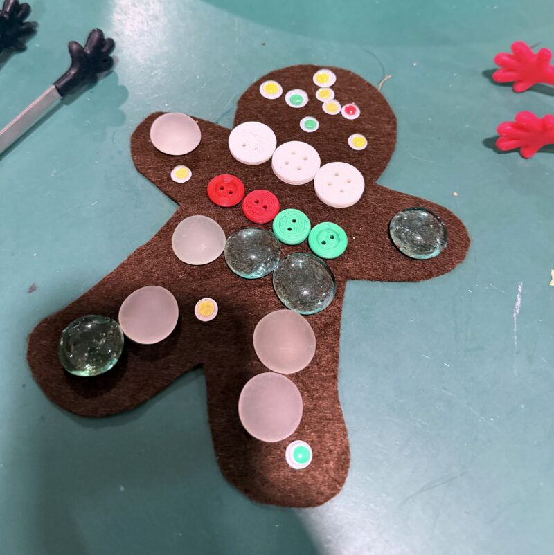 Paper gingerbread man decorated with 3D printed buttons