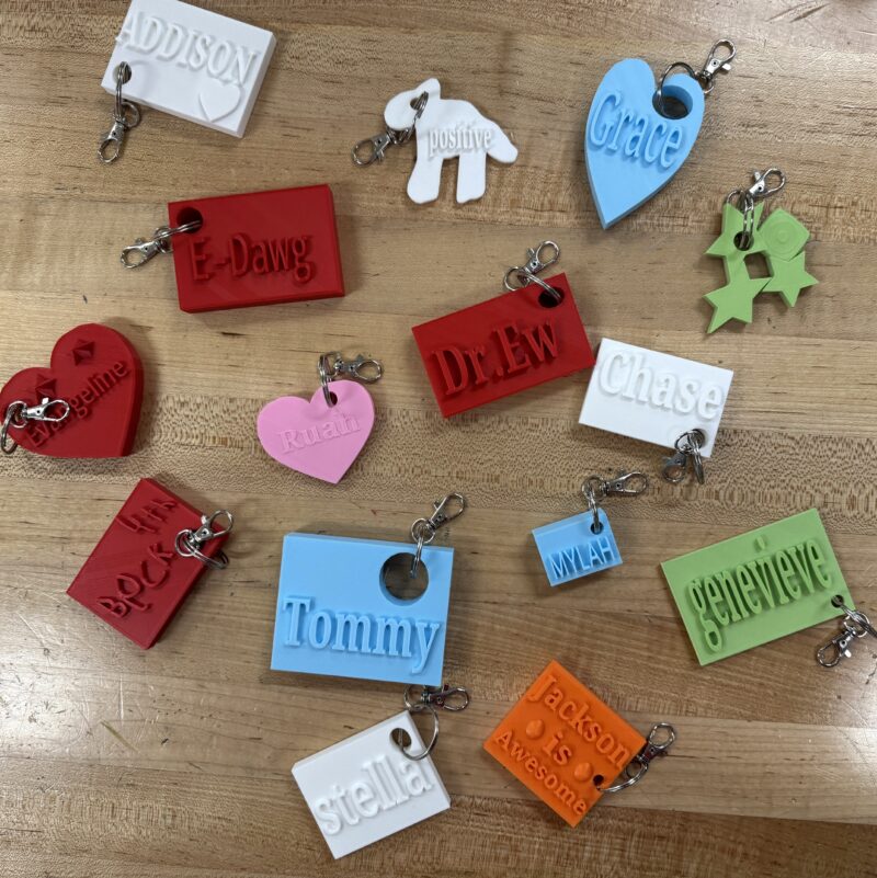 3D printed nametag keychains in a variety of colors