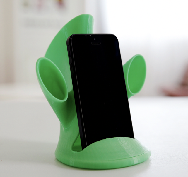3d printed green sound amplifier on phone