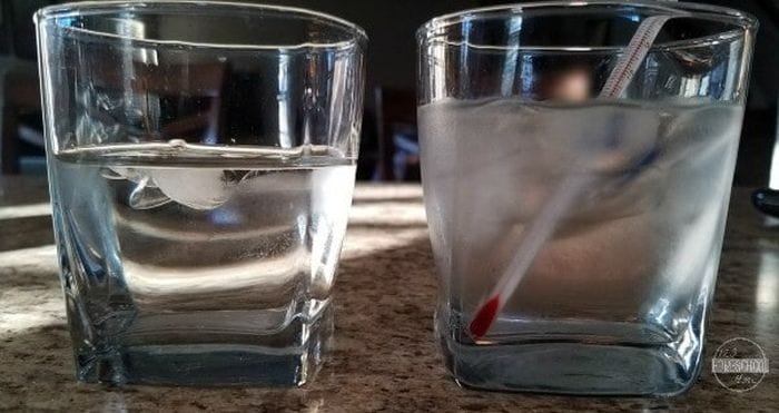 Two glasses of water, one with ice and a thermometer 