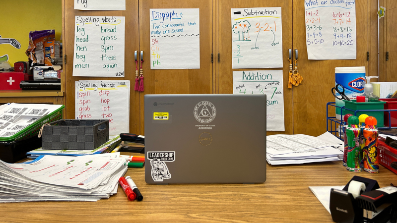 Photo of a Google Chromebook on a kidney shaped table in a classroom