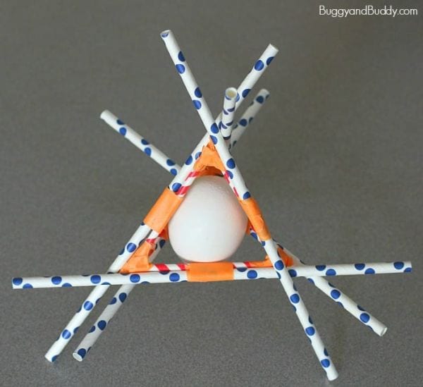 Paper straws taped around an egg in a triangle shape