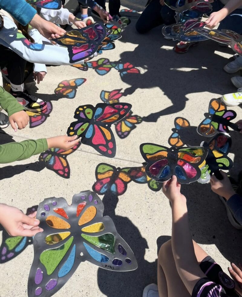 4th Grade Art: Butterflies Stained glass src butterflies made from paper, held up by 4th grade art students to show the light shining through
