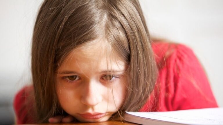 Girl with head on desk - 5 Toxic Phrases to Stop Using in the Classroom