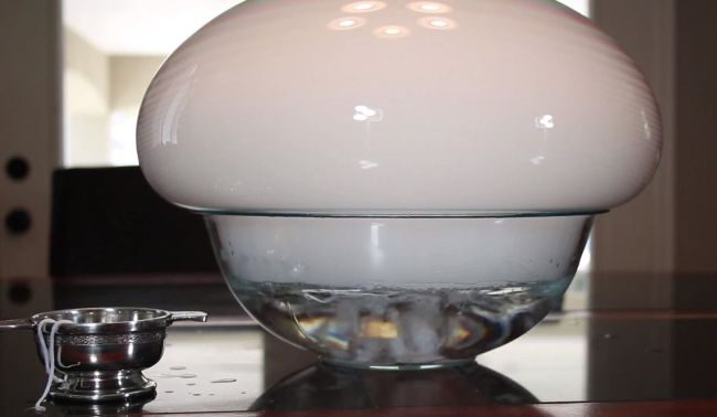 Glass bowl with a large bubble filled with dry ice vapor sitting on a table (Fifth Grade Science)