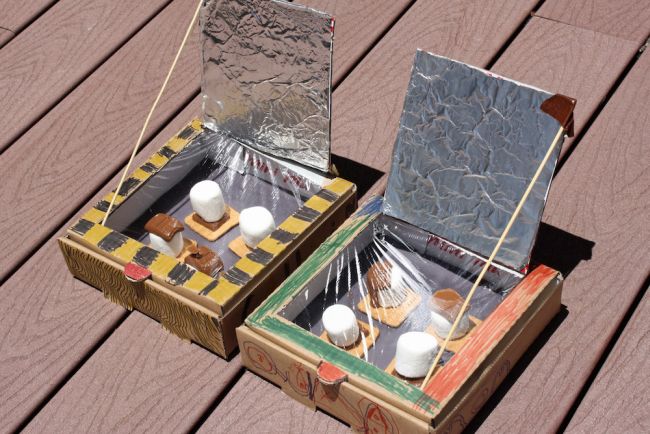 Solar ovens built from pizza boxes, with marshmallows, chocolate, and graham crackers