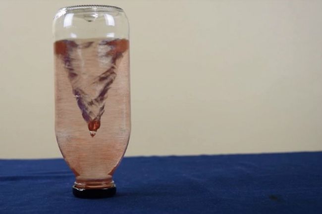 Upside-down bottle of water with a tornado spiraling inside