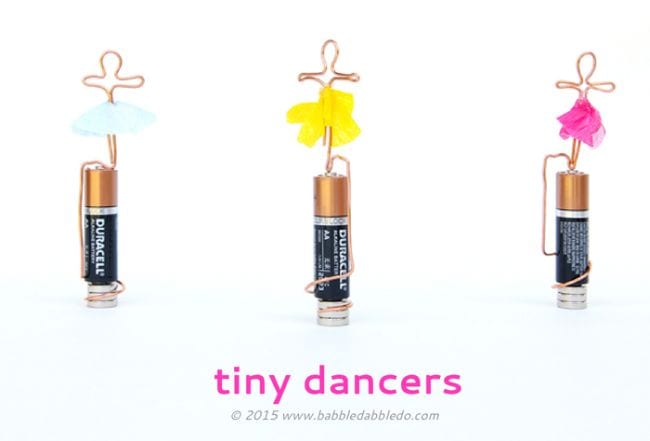 AA batteries with tiny wire figures twisted around them, with tutus added to look like ballet dancers