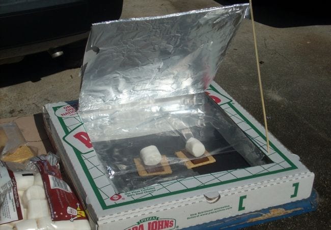 Pizza boxed turned into a solar oven, propped open with graham crackers, chocolate, and marshmallows inside 