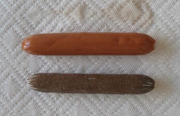 Two hotdogs, one smaller and darker than the other, on a paper towel (Easy Science Experiments)