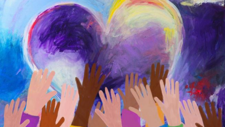Multicultural hands holding up a heart.