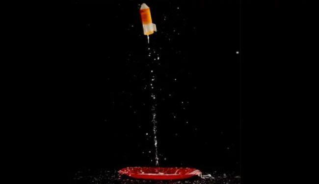 Film cannister rocket taking off from a red plastic plate (Eighth Grade Science)