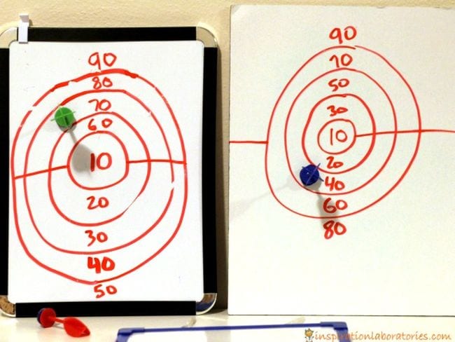 Two hand-drawn dartboards with darts on the 70 ring and 40 ring (Active Math Games)