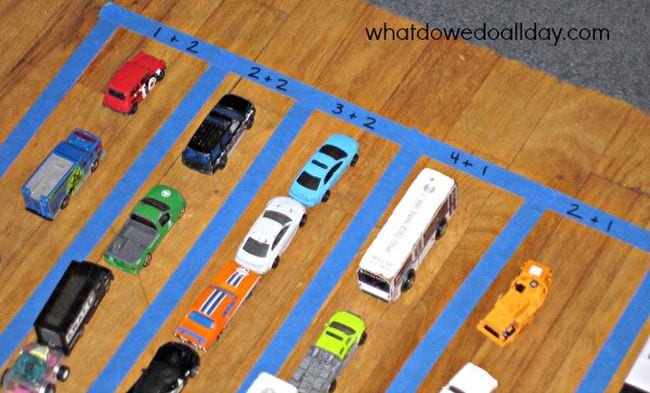 Toy cars lined up in rows to represent addition problems