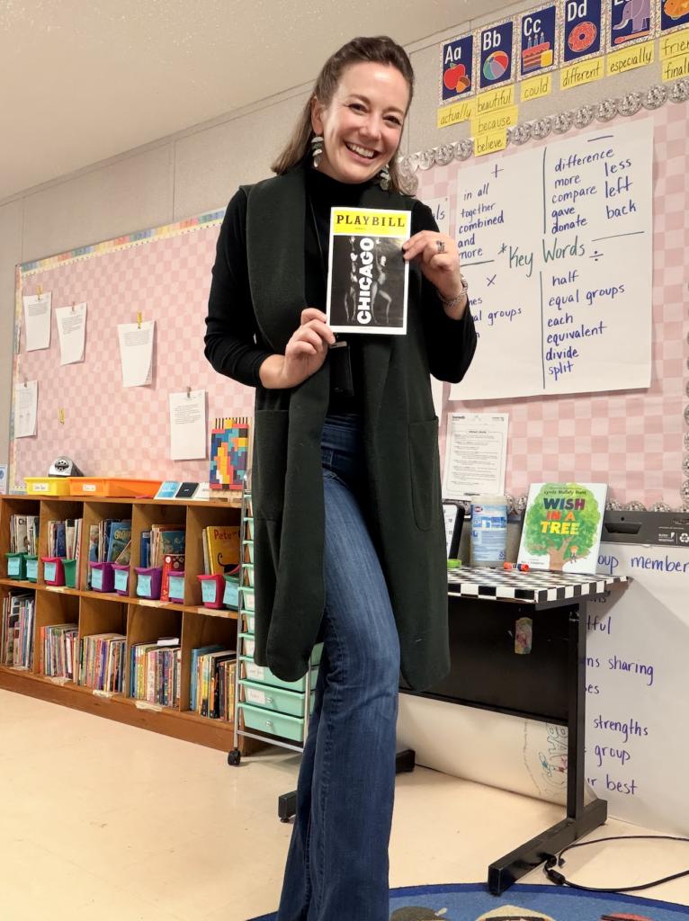 Allison in classroom holding playbill