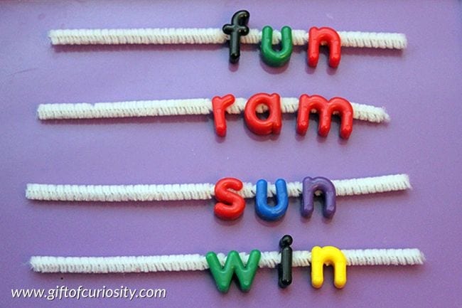 Pipe cleaners have letters strung on them.