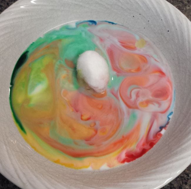 Dish soap, milk, and food coloring mixed in a bowl