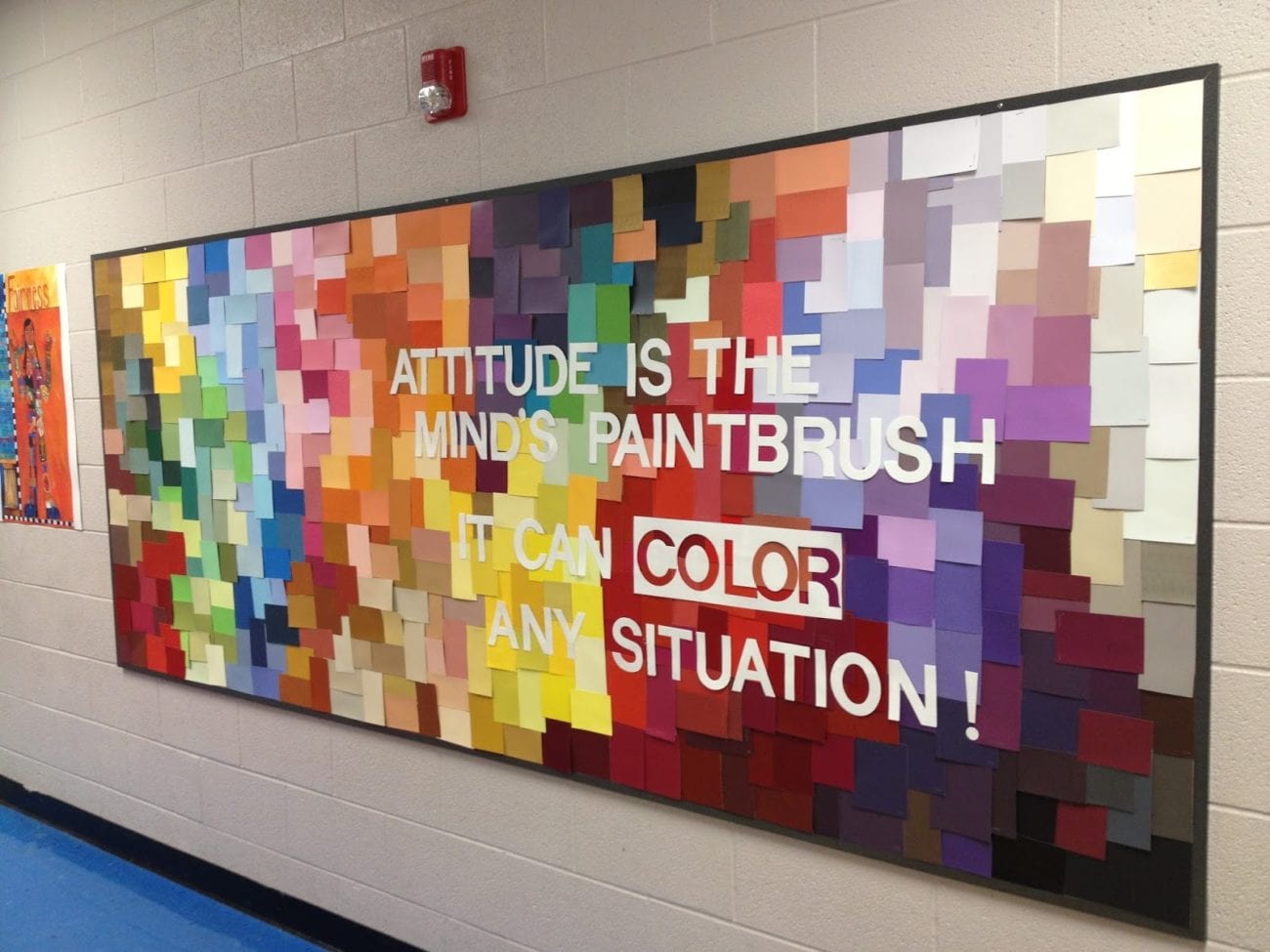 Rainbow bulletin board using paint swatches. The board says 