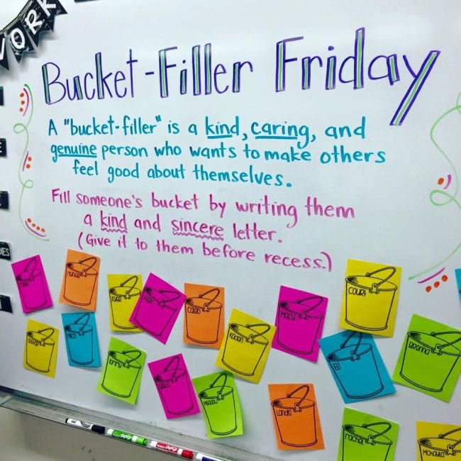 White board with text Bucket Filler Friday and colorful paper buckets as an example of bucket filler activities