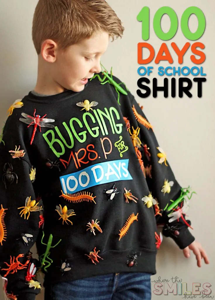 A little boy is wearing a black sweatshirt that has fake plastic bugs glued all over it. It says Bugging Mrs. P. for 100 days. 