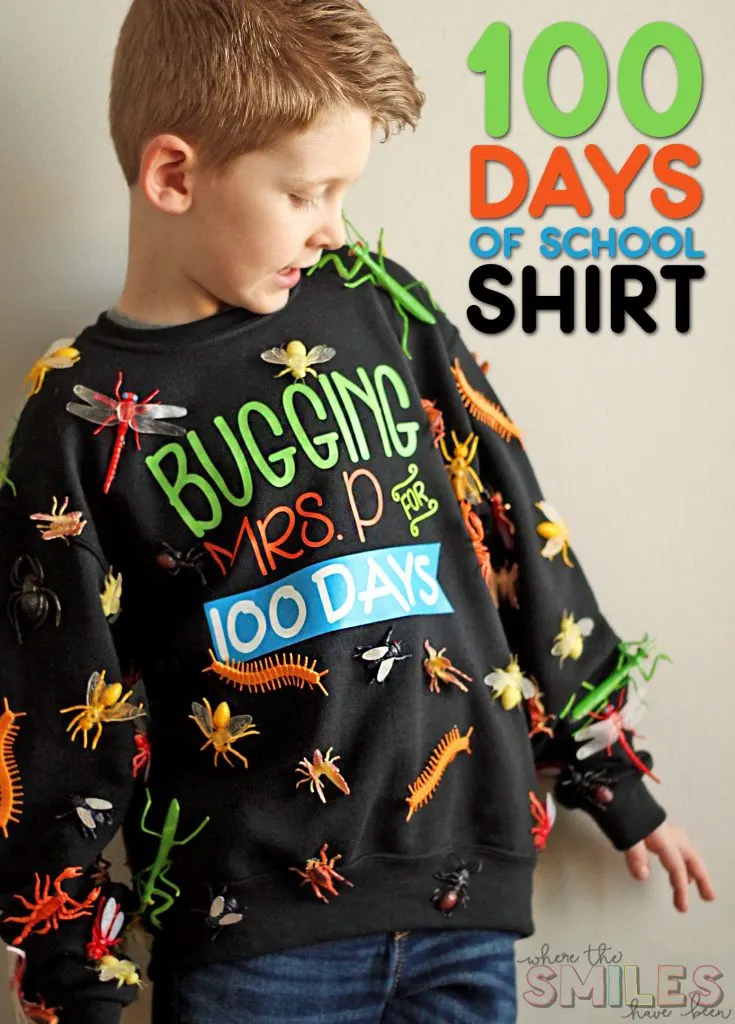 A little boy is wearing a black sweatshirt that has fake plastic bugs glued all over it. It says Bugging Mrs. P. for 100 days.