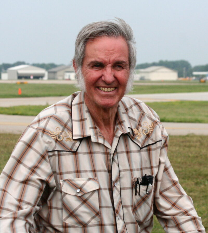 A man is seen wearing a plaid shirt and smiling in this photo of Burt Ratan on the list of Famous Engineers.