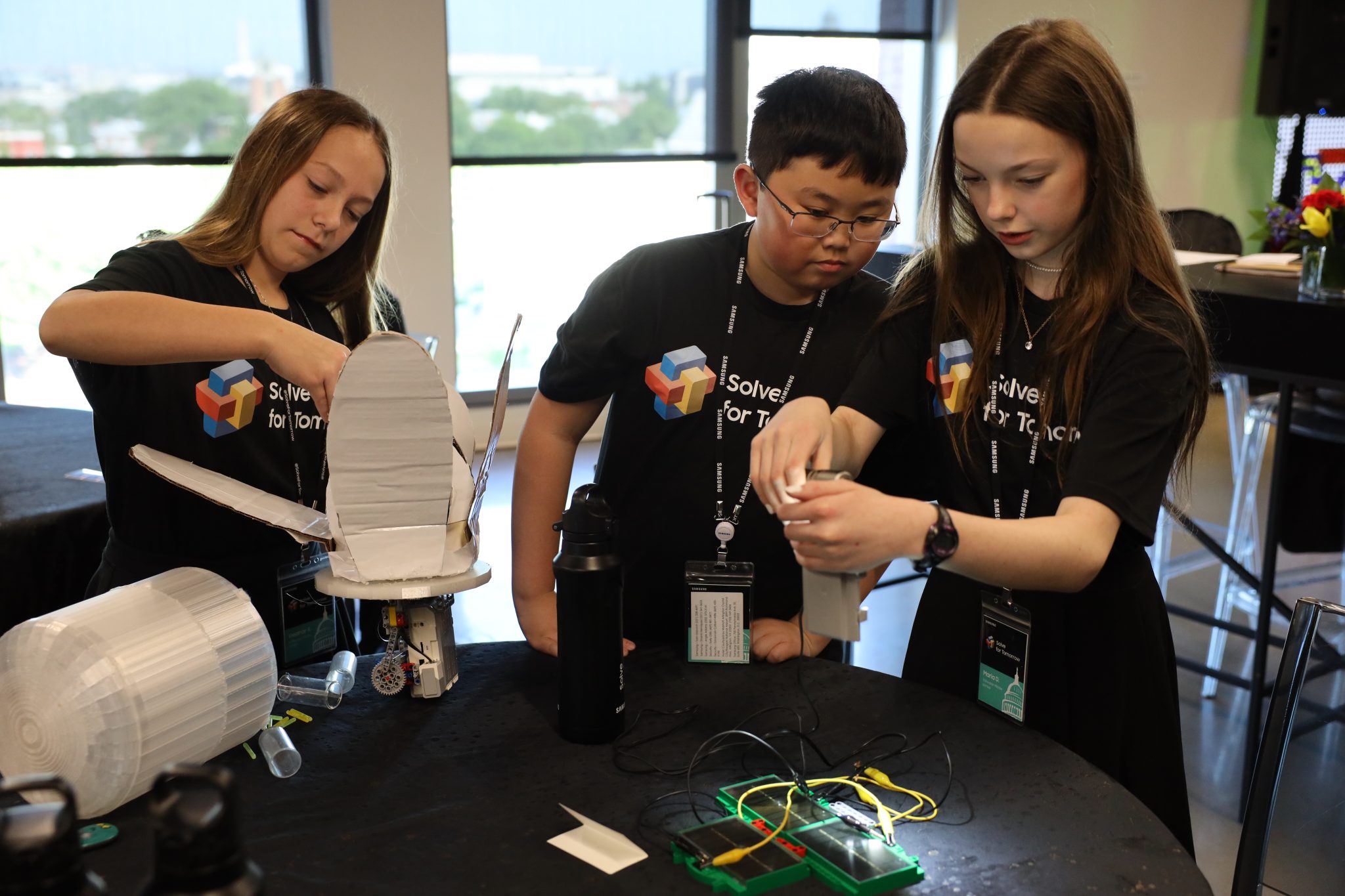 Middle schools students in a classroom working on a project for Samsung Solve for Tomorrow.