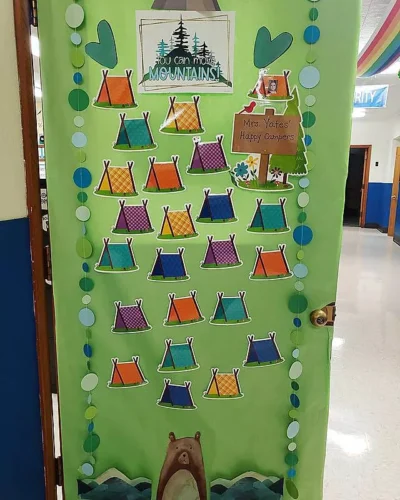 you can move mountains classroom door with tents and a camping theme