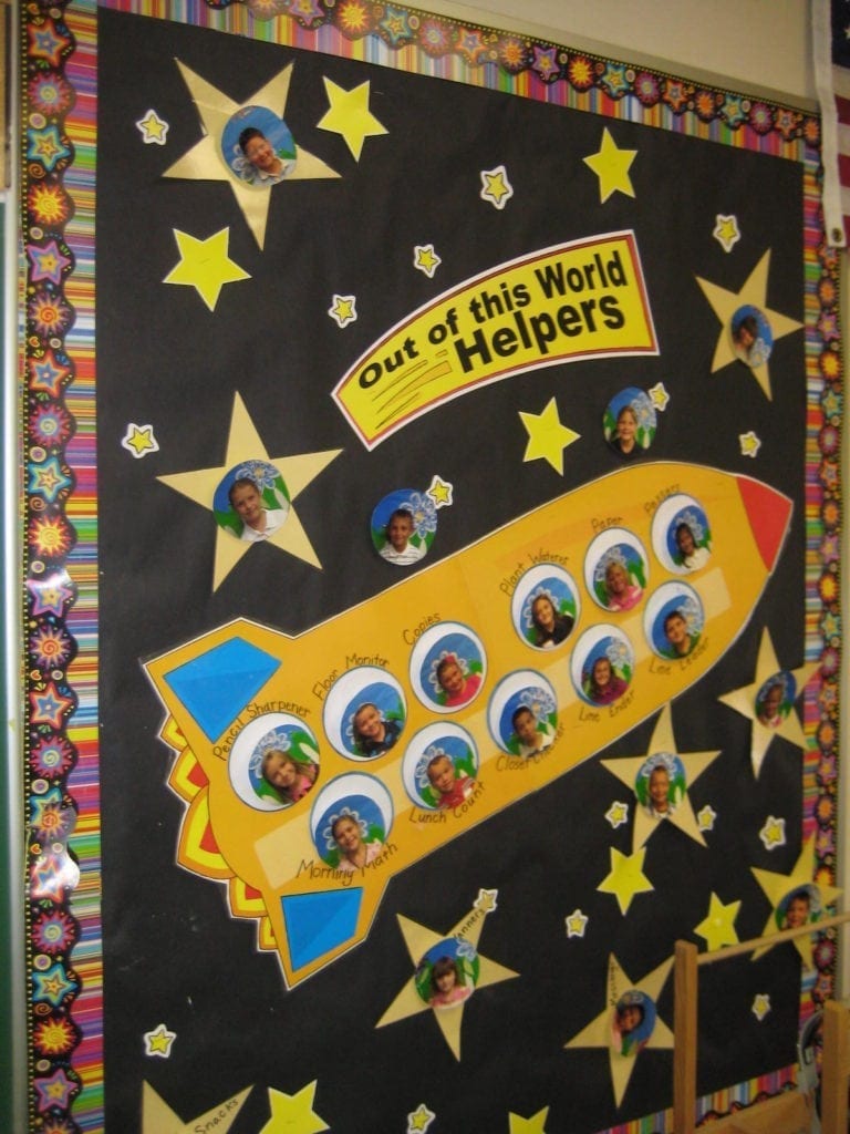 Space-themed classroom bulletin board celebrating "out of this world helpers"