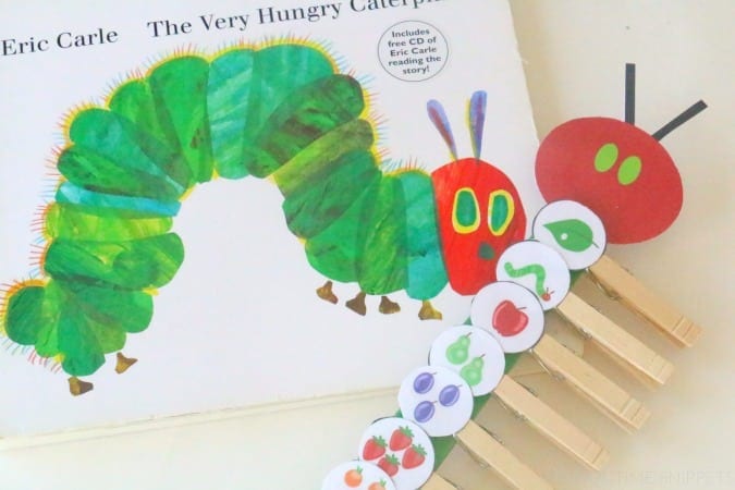 A story retelling tool for the book The Very Hungry Caterpillar made from a paper caterpillar body and head with clothespins with pictures of different food attached to it