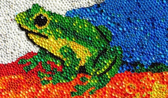 This collaborative art project is made from plastic water bottle caps that are painted and come together to form a picture of a frog.
