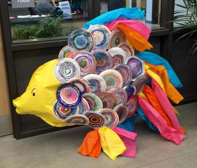 Large paper fish with individually decorated paper plates for the scales and tissue paper tail and fins