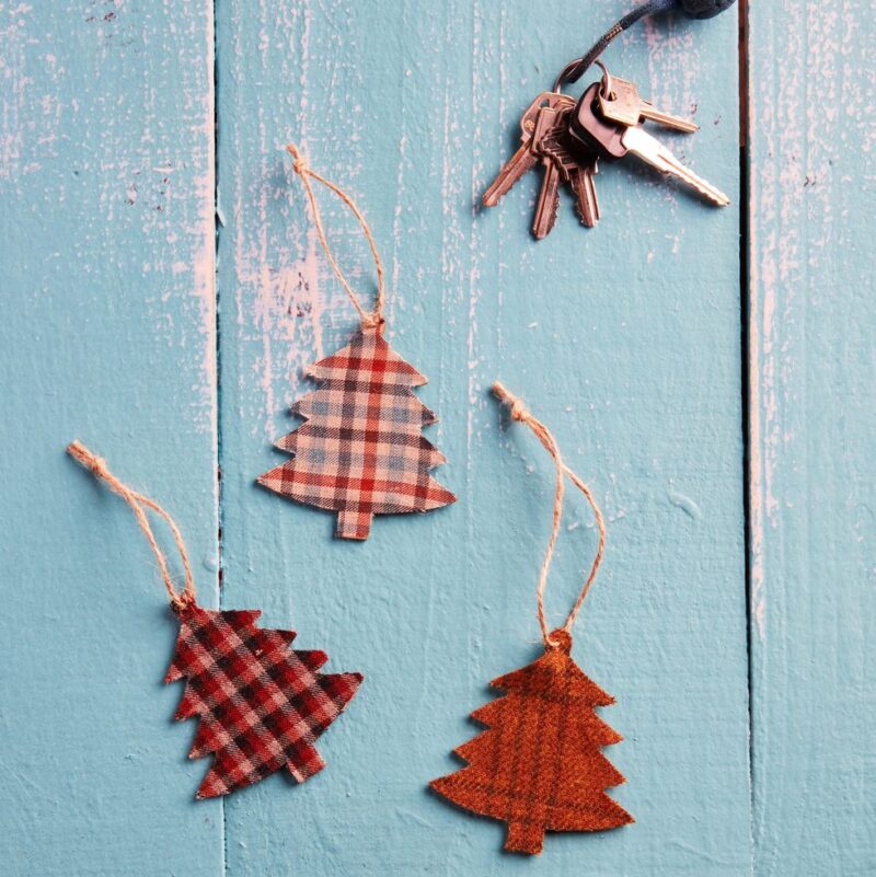 several tree shaped air fresheners are made from plaid fabric.