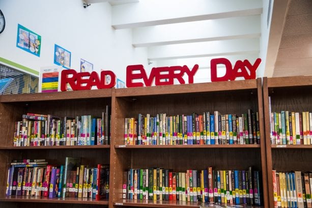 'Read every day' sign above library books