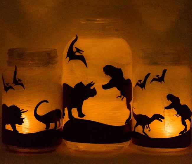 Paper lanterns with silhouettes of dinosaurs