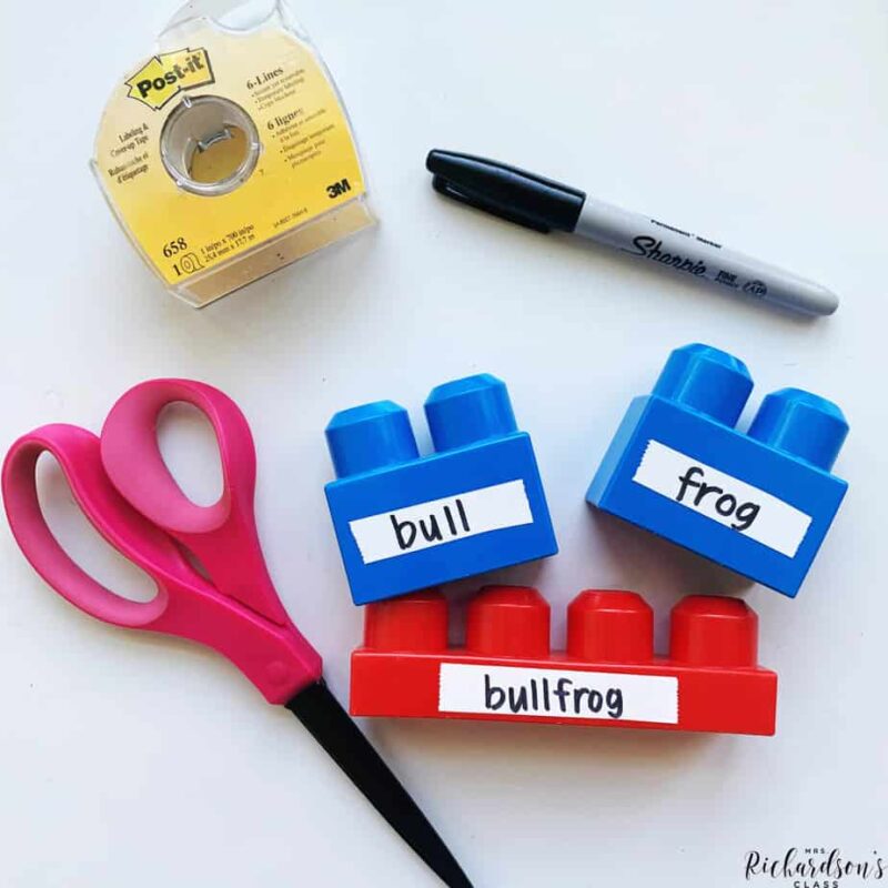 Blue duplo blocks fitting onto a bigger red duplo block to combine word parts