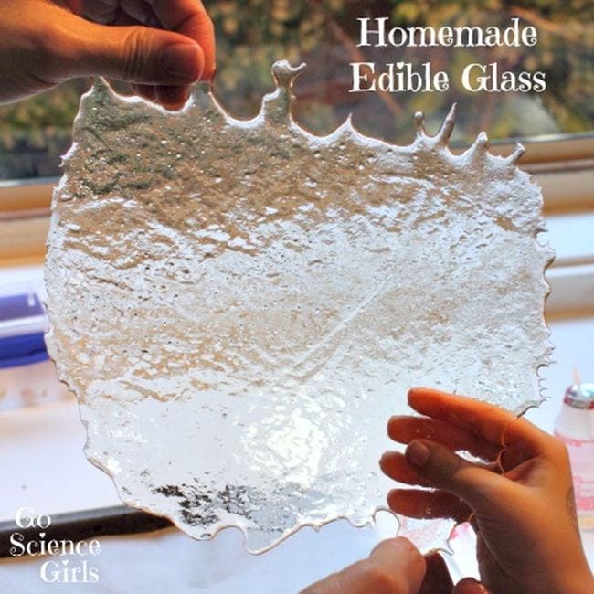 Student holding a sheet of "glass" made from melted sugar. Text reads Homemade Edible Glass.