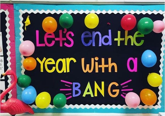 Bright block letters spell Let's end the year with a bang. Balloons in different colors are attached. 