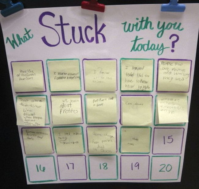 A poster reading "What stuck with you today?" with sticky note responses posted below