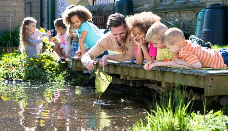 Children looking at pond