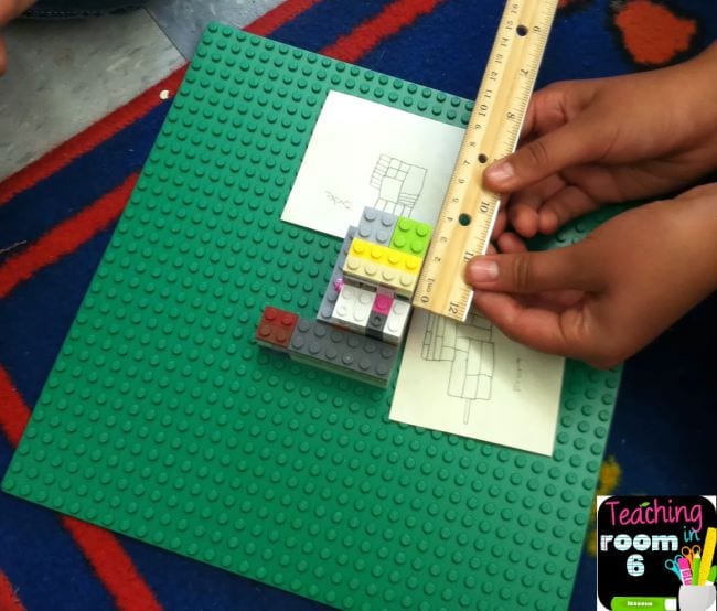 Student using a ruler to measure LEGO bricks