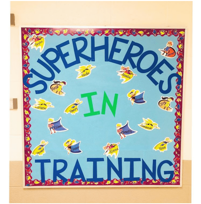 Superheroes in Training bulletin board with cartoon images of superheroes labeled with kids names