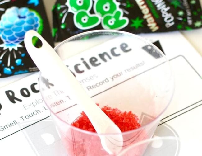 Plastic cup of red Pop Rocks with a small spoon and Pop Rocks Science worksheet to teach the five senses