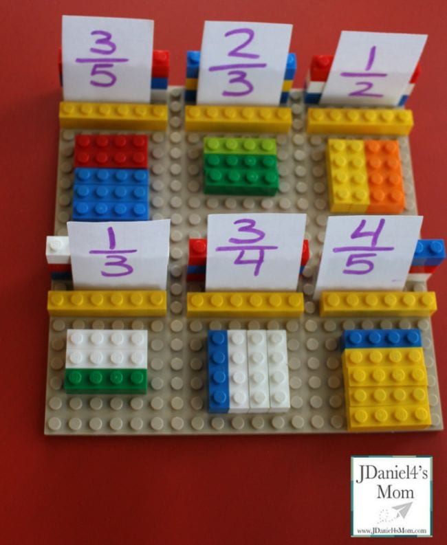 LEGO bricks laid out to represent fractions with fraction cards propped up on them (Fraction Games)