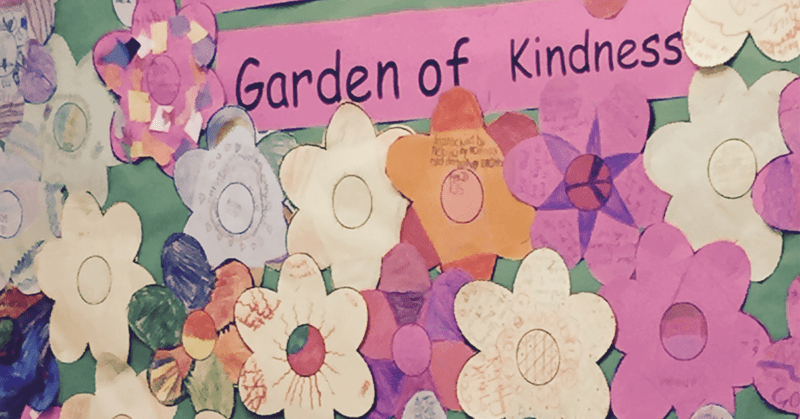Garden of Kindness bulletin board with paper flowers with kind notes written on them by students